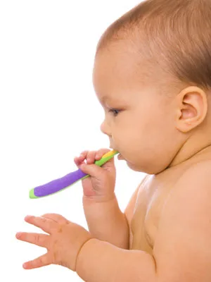 baby with toothbrush