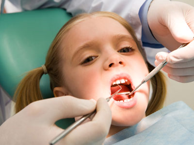 girl receiving dental exam